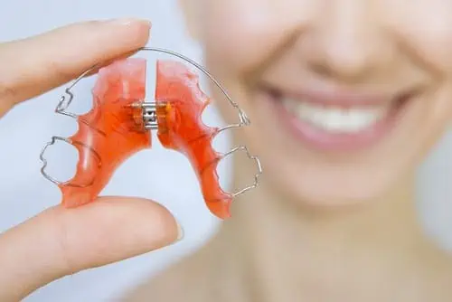 woman holds retainer